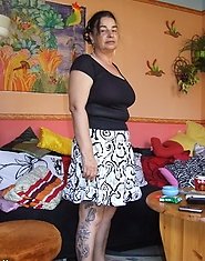 Tatooed mature slut showing her pussy